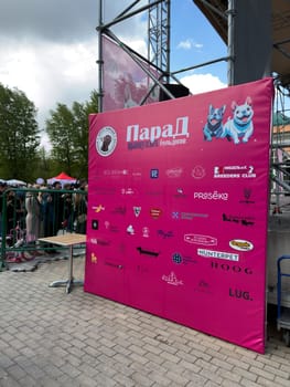 Moscow, Russia, April 27, 2025: Large vertical sponsor banner highlights logos of supporting pet brands and partners at the French Bulldog Parade in Vorontsovsky Park