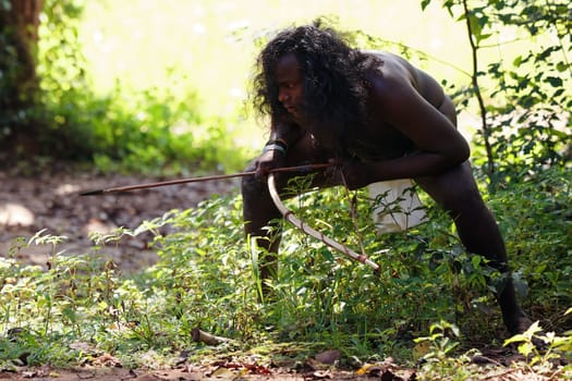 Vedda tribesman of Sri Lanka Hunting in the jungle with a bow and arrow, traditional lifestyle, and connection to nature. Tribal portrait in native Habitat. 02.03.2022 SRI LANKA.