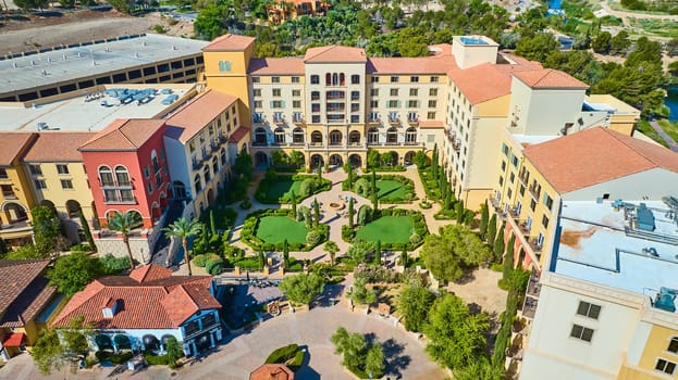 Aerial view of a Mediterranean-style resort at Lake Las Vegas Nevada featuring red-tiled roofs lush courtyard and boutique shops perfect for luxury travel leisure and real estate marketing