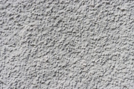 Grey Cement wall background. Empty wall background. Weathered rough textured stucco wall painted gray-white..