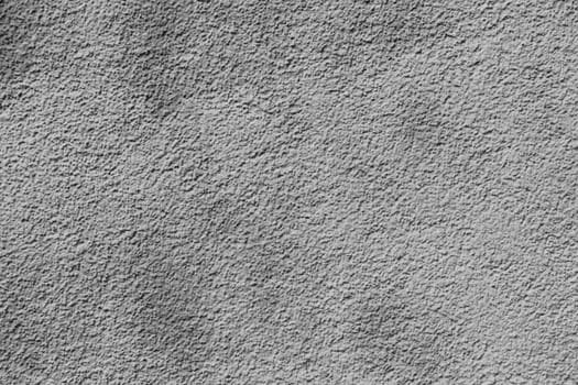 Empty wall background. Weathered rough textured stucco wall painted gray-white.