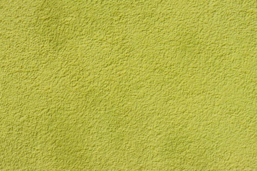 Old concrete plastered wall covered with yellow paint. Bright yellow wall surface.