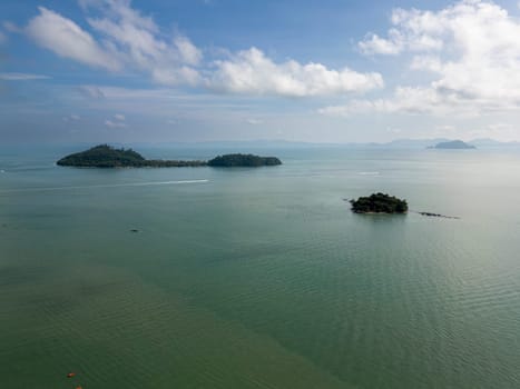 Breathtaking drone shot above Thailand seashore and beach, featuring a beautiful bay, sailboats and coastal cliffs. Tropical natural beauty on the coastline creating an exotic landscape.