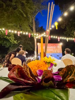 Bangkok, Thailand - November 10, 2024: Traditional floral arrangement for a religious Thai ritual floating on water, sacred tribute featuring colorful flowers. Loy Krathong spiritual ceremony.