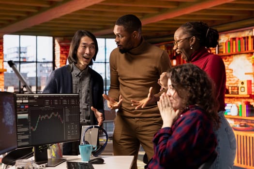 Happy startup team celebrating milestone after company goes public through IPO, obtaining capital. Tech business securing angel investments after proving rapid technological advancement