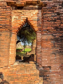 Historic remains of a Buddhist temple stand in peaceful silence in Thailand, showcasing traditional sacred architecture and cultural heritage. Wat Maha That offers a spiritual retreat.