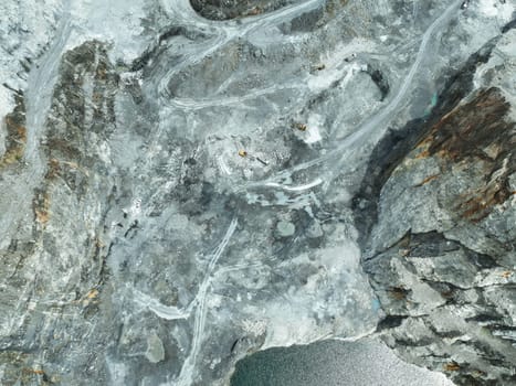 Open pit mine industry. Limestone quarry with backhoe and truck in operation. Heavy machinery in mining industry and construction material supply. Landscape of resource extraction in a industrial site
