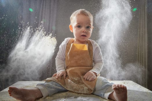 A boy explores the texture of flour while playing in a studio, showcasing a fun and creative cooking activity.