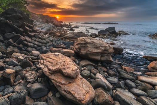 Panoramic landscape with basalt columns Ganh Da Dia on the beach by sea. Da Dia reef in Vietnam at sunrise