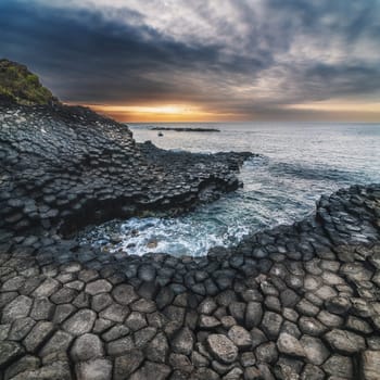 Landscape with basalt columns on rocky beach by the sea. Da Da reef in Phu Yen province in Vietnam at sunrise