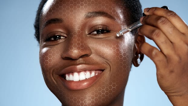 A woman with a radiant smile is applying a skincare serum to her face. The clear blue background enhances the focus on her joyful expression and glowing skin, promoting a healthy skincare routine.