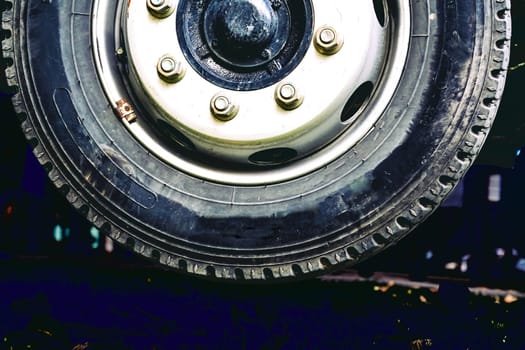 a circular object that revolves on an axle and is fixed below a vehicle