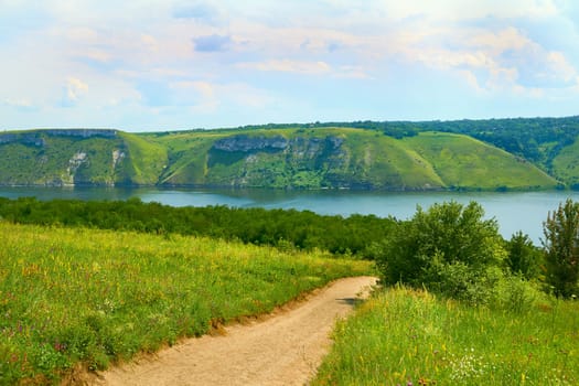 a wide way leading from one place to another, especially one with a specially prepared surface