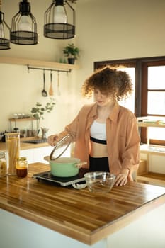 Young woman preparing a meal with fresh ingredients in a stylish kitchen.