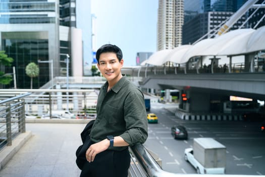 Confident businessman taking a break in a bustling commercial district.