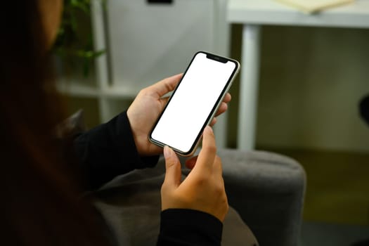 Mockup image of female hand holding smartphone with blank display.