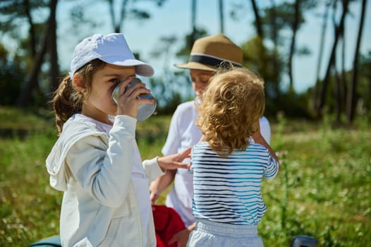 A happy family enjoying a picnic in the sunny outdoors, showing love and connection amid a scenic mountain background.