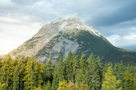 A breathtaking scenic mountain view that is beautifully surrounded by lush.