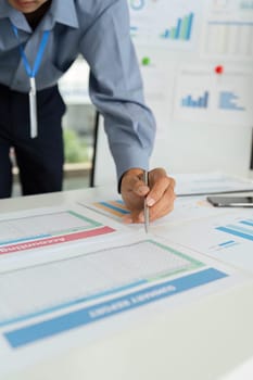 A businessman takes notes while reviewing financial data, showcasing dedication to analysis and strategic planning.