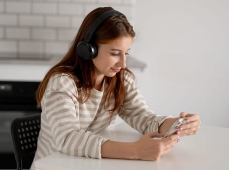 Happy Teen Girl Using Smartphone With Headphones