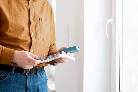 Man Measuring A Window Opening With A Special Device In Close-Up