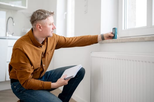 Man Measuring Window Height With A Special Device