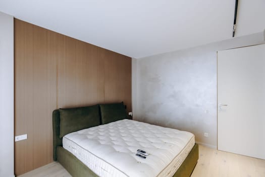 This is a cozy bedroom, which includes a comfortable bed accompanied by a soft mattress placed in the designated space