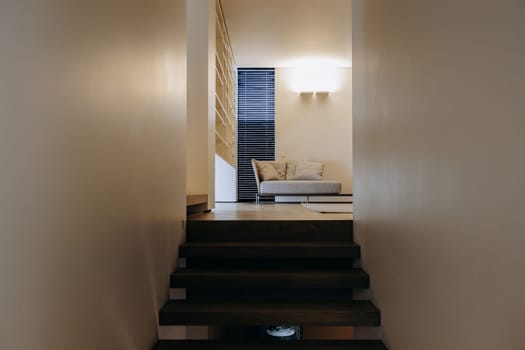 There is a staircase that leads up to a cozy living room where you can find a comfortable couch for relaxation and enjoyment