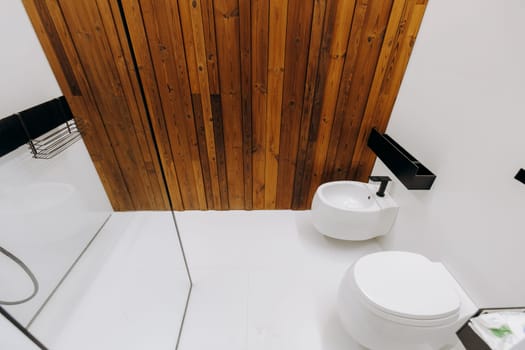 The bathroom features essential fixtures including a modern toilet, a stylish sink, and a convenient shower for a complete experience