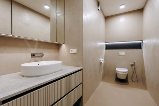 A bathroom that includes essential fixtures such as a sink, a toilet, and a mirror for personal grooming and hygiene needs