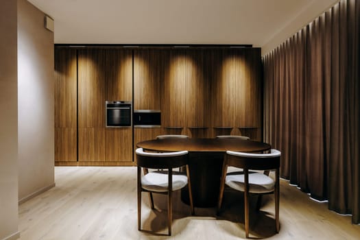 A beautifully designed dining room featuring an elegant wooden table complemented by matching chairs that enhance the overall aesthetic