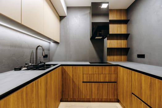 An inviting kitchen featuring beautiful wooden cabinets, a fully functional sink, and a modern stove for all your cooking needs
