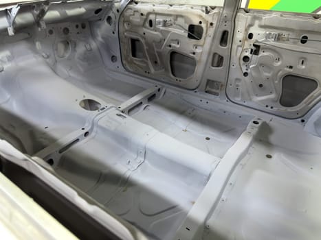 Restored car interior with visible tunnel reinforcement and detailed floorpan shaping, highlighting structural preparation for performance upgrades and racing modifications