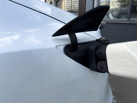 Electric car being charged, reflecting the shift from traditional fuel refueling to modern plug in energy solutions in today sustainable transportation reality