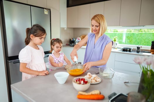 Family fun unfolds as children help mix ingredients joyfully.