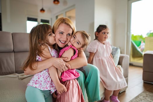 Children embrace their mother with joy and laughter.