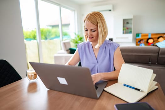 Professional woman typing on her laptop, enjoying her workspace.