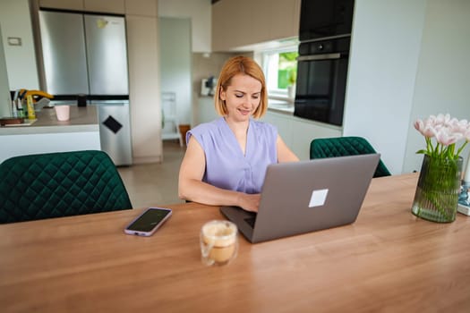 Concentration fills the air as a woman types away on her laptop.