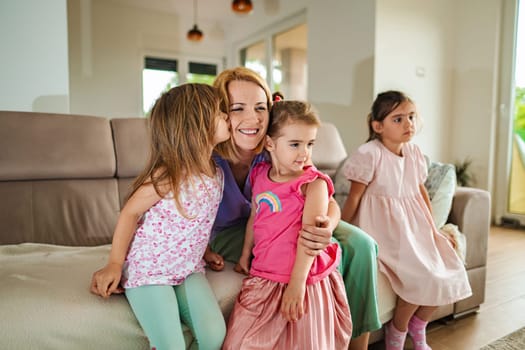 Happy children share a loving embrace with their mother.