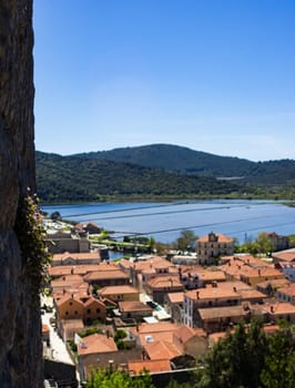 Medieval walls in Ston. Exotic experience of natural and historical beauty in Ston, Croatia. Vertical picture. Ideal for travel promotions and Social media posts. Summer Tourism in Europe