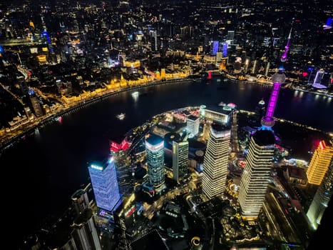 Shanghai, China - 1 April 2025: Aerial night view of Lujiazui and the Bund from Shanghai Tower with city lights, Huangpu River, and Oriental Pearl Tower.