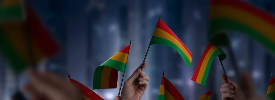 Bolivia flags in their hands on a blurred urban background. The photo illustration was created without the use of artificial intelligence, only using Photoshop.