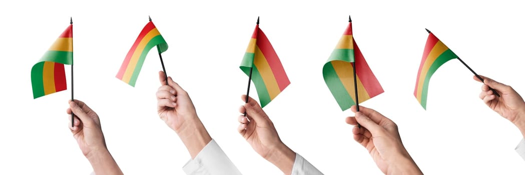 The Bolivia flag in hand in different angles on a white background.