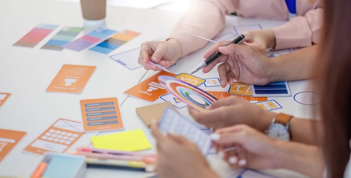 A team of designers collaborates on layout concepts and color selections, enhancing creativity and project development.