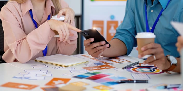 Design professionals engage in a creative process, analyzing designs and discussing ideas in a collaborative workspace.