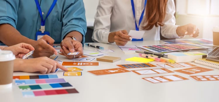 A team of design professionals collaborates on layout designs and color choices, fostering creativity and innovation in a workspace.