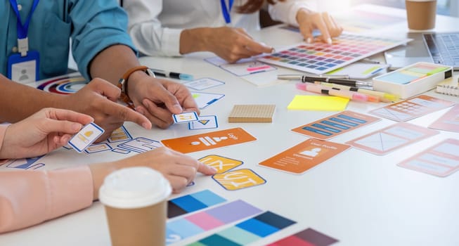 A diverse team engaging in a creative design session, discussing UI UX prototypes and color schemes to enhance user experience.