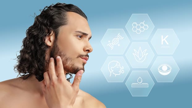 A man with curly hair inspects his beard while considering various natural skincare components like aloes and vitamins. The background features scientific icons representing skincare.