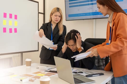 A team of professionals discusses project stressors, showcasing teamwork and collaboration to resolve challenges in a bright office space.