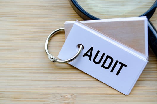 Audit text on notepad symbolizing financial review and compliance evaluation.